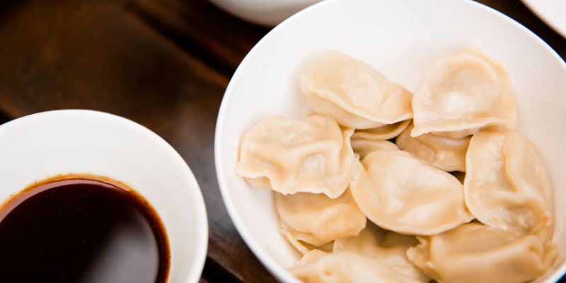 Dumplings in a bowl with Worcestershire dipping sauce bowl