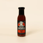 Bottle of Corporal Freddie's Tomato Sauce on a beige background