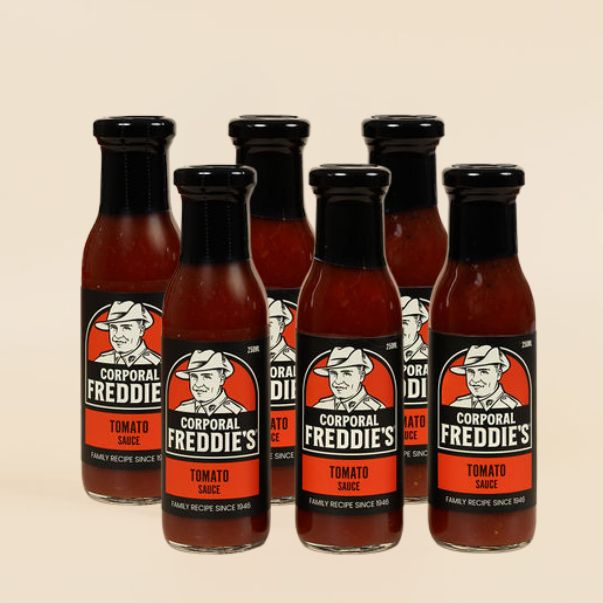 Six bottles of Corporal Freddie's Tomato Sauce on a beige background