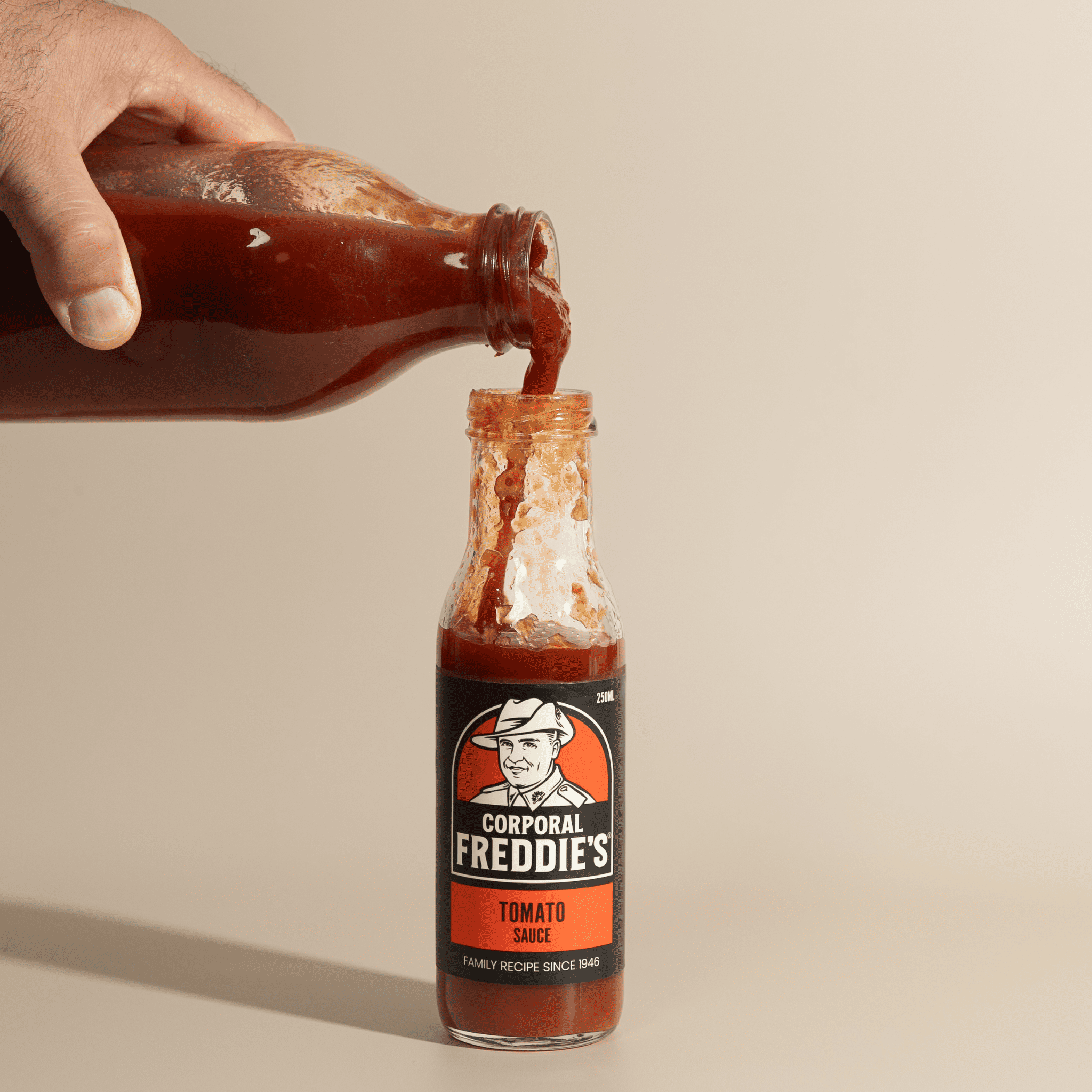 pouring refill bottle into 250ml Tomato Sauce bottle